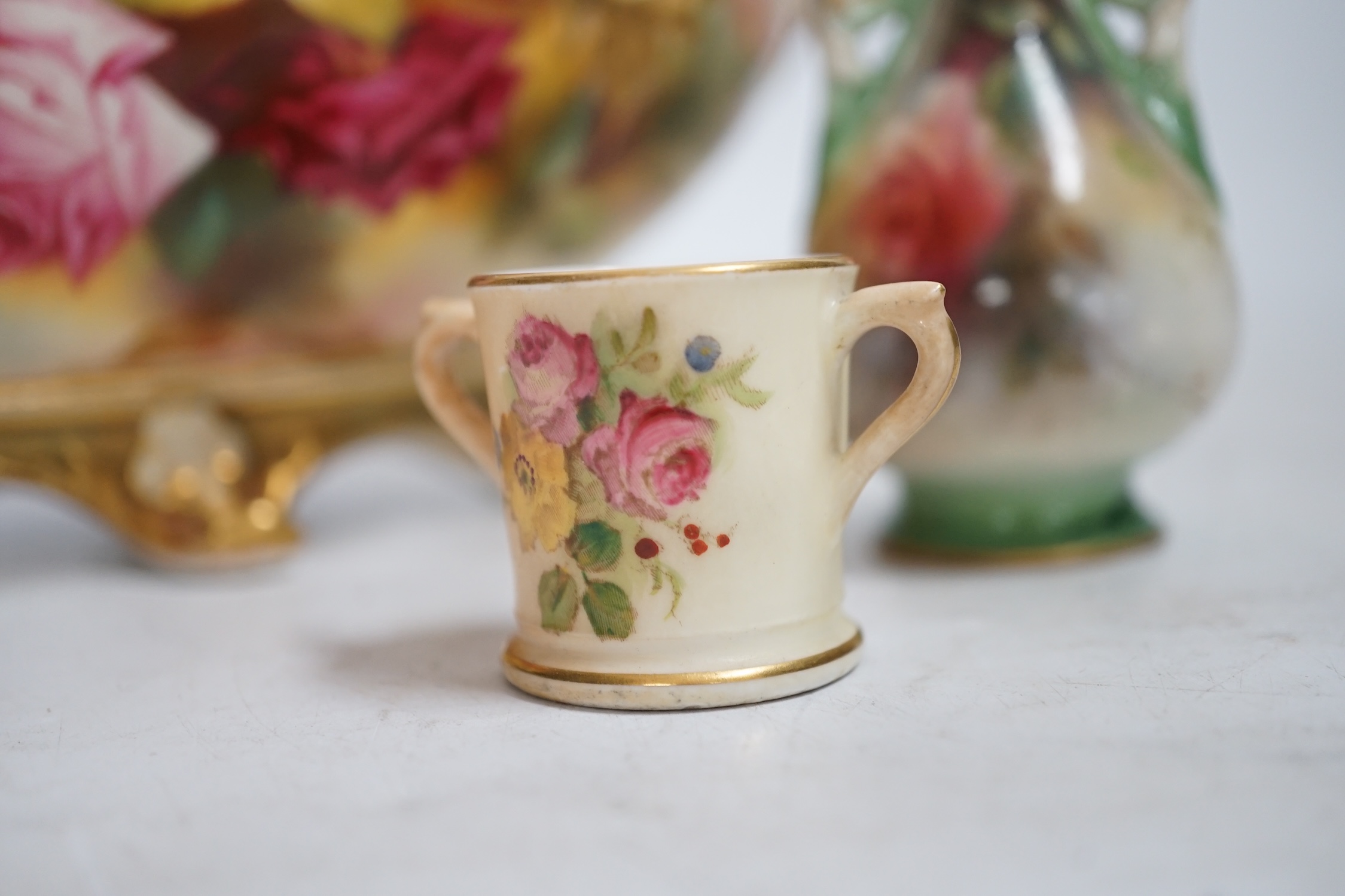 A Royal Worcester floral painted, twin handled dish, painted by Ethel Spilsbury, together with a miniature Worcester blush mug and a Hadley Worcester vase, dish 23.5cm wide. Condition - poor-fair